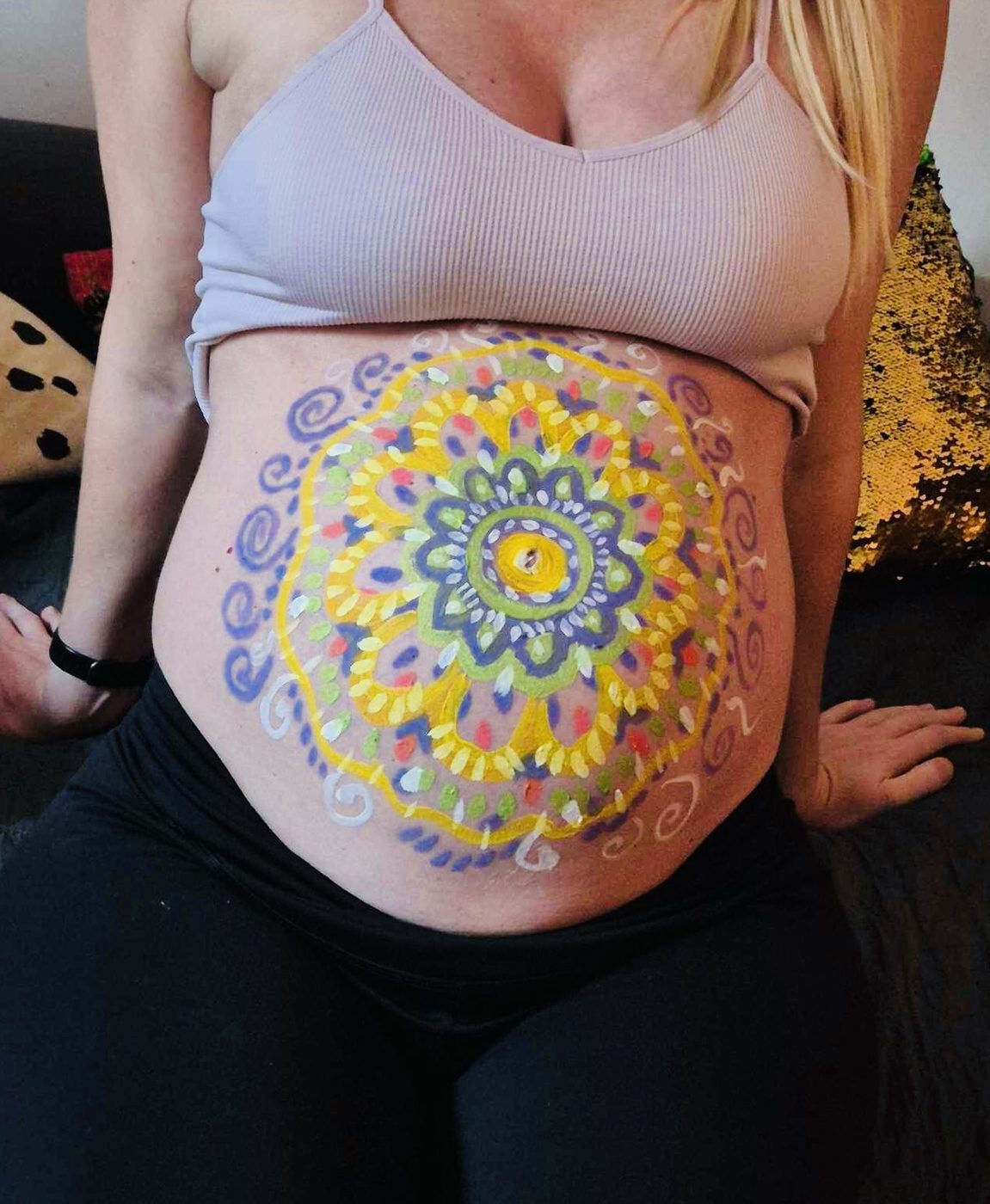 Yellow and purple mandala on a pregnant belly