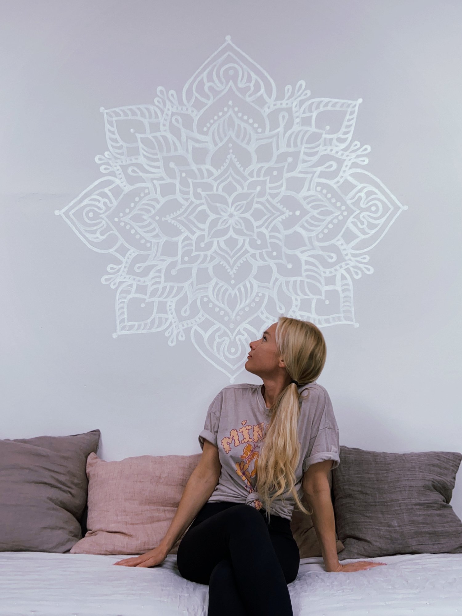 White mandala on a grey wall